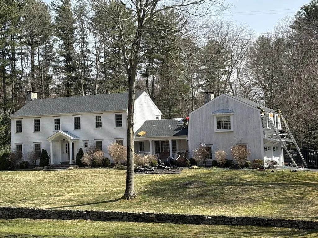 Colonial home and attached barn with a new asphalt shingle roof by Fulcrum Contracting